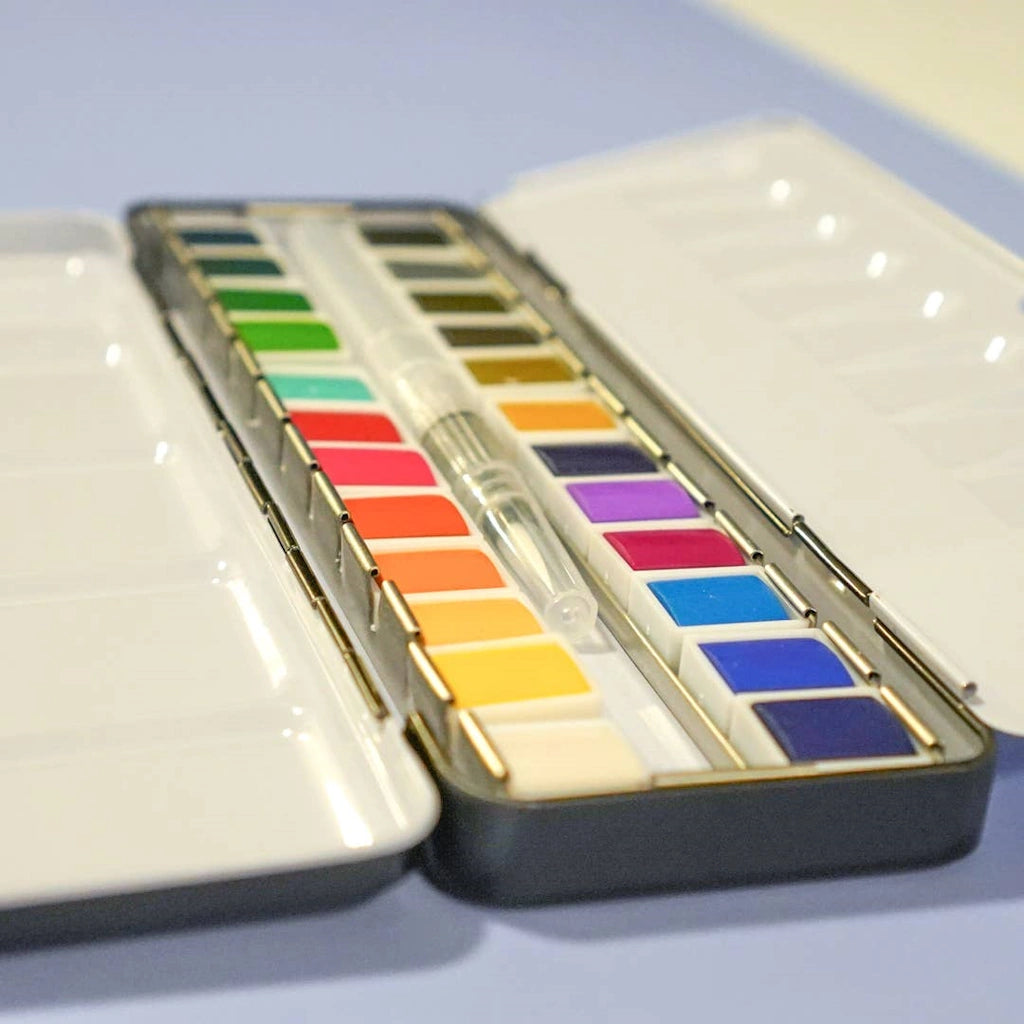 24 Color Watercolor Palette paint set available from Campanula Design Studio in Seattle. Pair this with some of our watercolor books and cards, add a flower arrangement, or a gift basket.