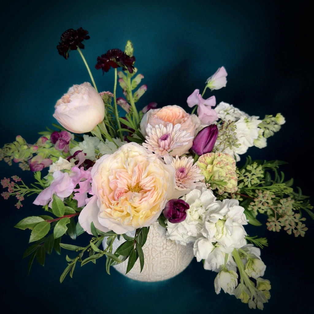 Campanula Design Studio presents Blackberry Bramble, a flower arrangement featuring a gorgeous combination of creamy whites and pinks combined with sultry purples and pops of lavender designed in a ceramic vase. Available for Seattle area delivery.