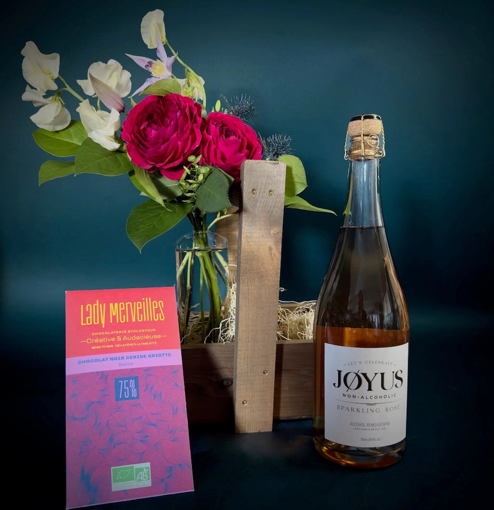 The non-alcoholic version of our popular Cheers! gift basket features wine removed non-alcoholic wine by local Seattle maker Jøyus alongside a small bud vase of flowers and a bar of award winning Lady Merveilles chocolate.