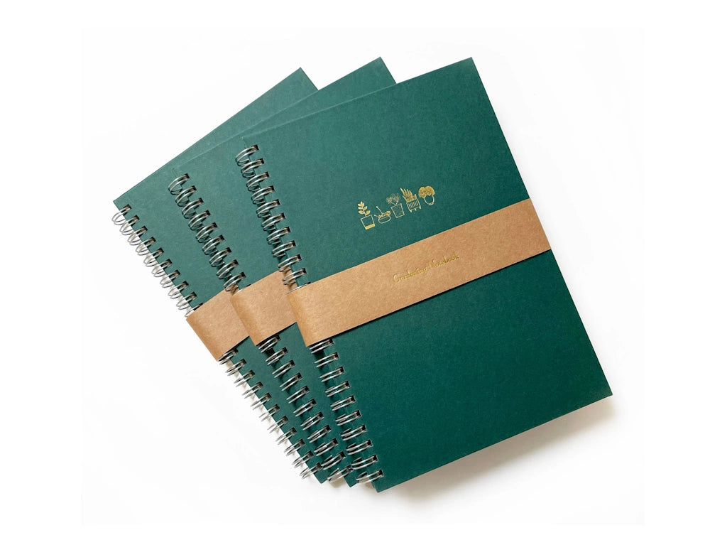 Keep your gardening notes organized in style with these tidy, handy spiral-bound notebooks, foil pressed in gold with a row of five sweet potted plants. Available from Campanula Design Studio, Seattle's premier gift shop and florist.