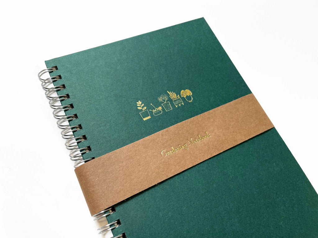 Keep your gardening notes organized in style with these tidy, handy spiral-bound notebooks, foil pressed in gold with a row of five sweet potted plants. Available from Campanula Design Studio, Seattle's premier gift shop and florist.