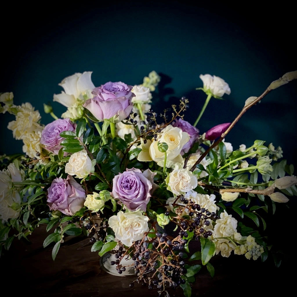 Campanula Design Studio presents this stunning collection of creamy white flowers, the softest of yellows, and shades of lavender designed in a simple vase.