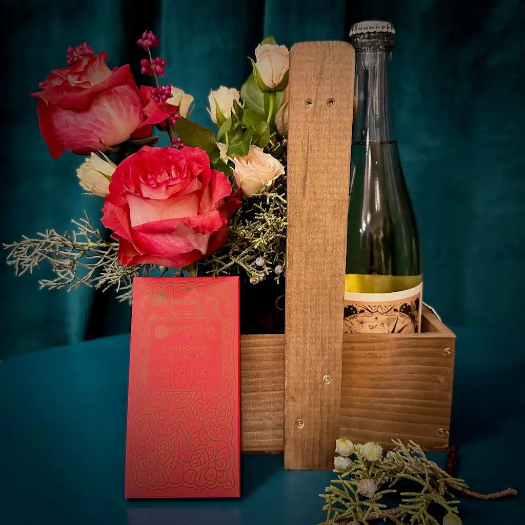 Holiday themed Wine and flowers in a custom wooden gift tote. Add chocolate or a candle for the perfect host gift.