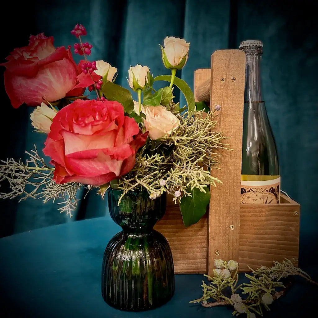 Holiday themed Wine and flowers in a custom wooden gift tote. Add chocolate or a candle for the perfect host gift.