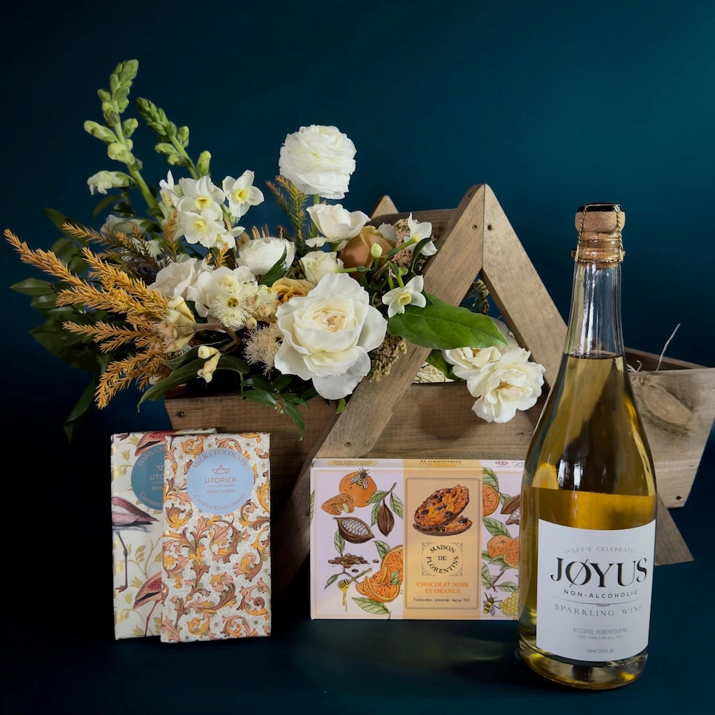 This gift basket is called "Joyful", and features non-alcoholic wine, two premium chocolate bars and a box of delicious florentins.