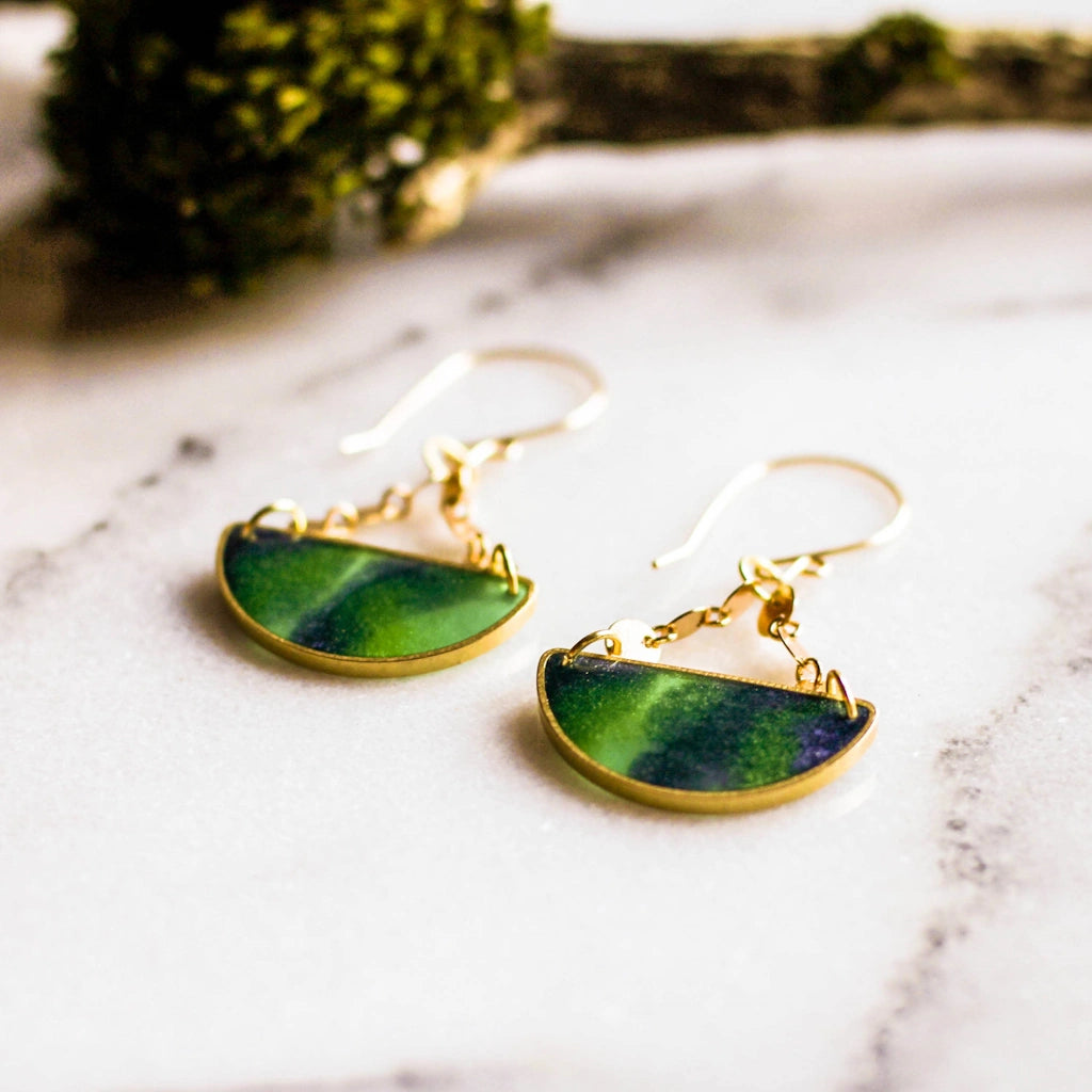 Reminiscent of the mysterious green and blue streaks of the aurora borealis, these half-circle raw brass earrings are substantial, yet lightweight.  Available for nationwide shipping, or stop by our Magnolia neighborhood florist and gift shop in Seattle.