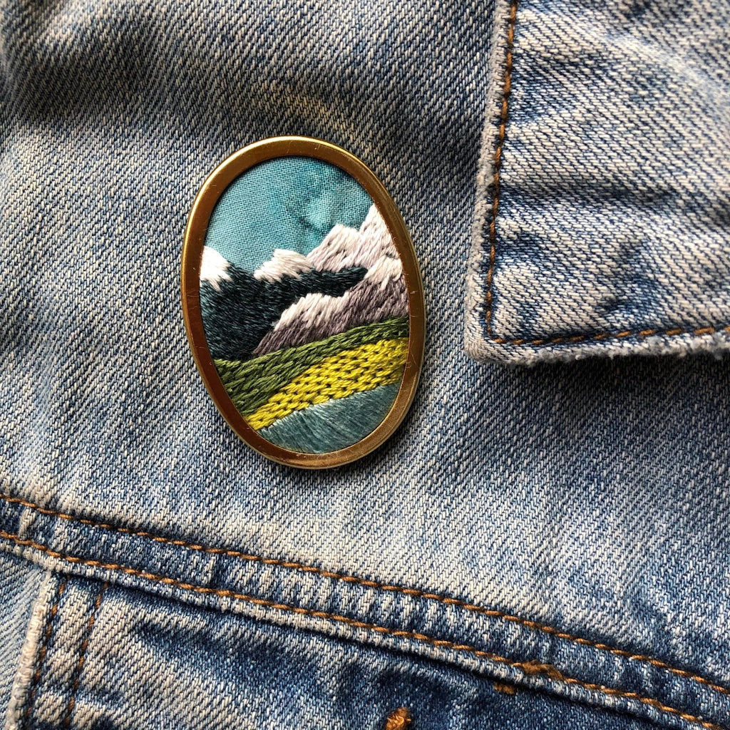 Give the gift of crafting to your crafty friend. This embroidery kit lets you create your own oval landscape pin. Available from Campanula Design Studio in Seattle.