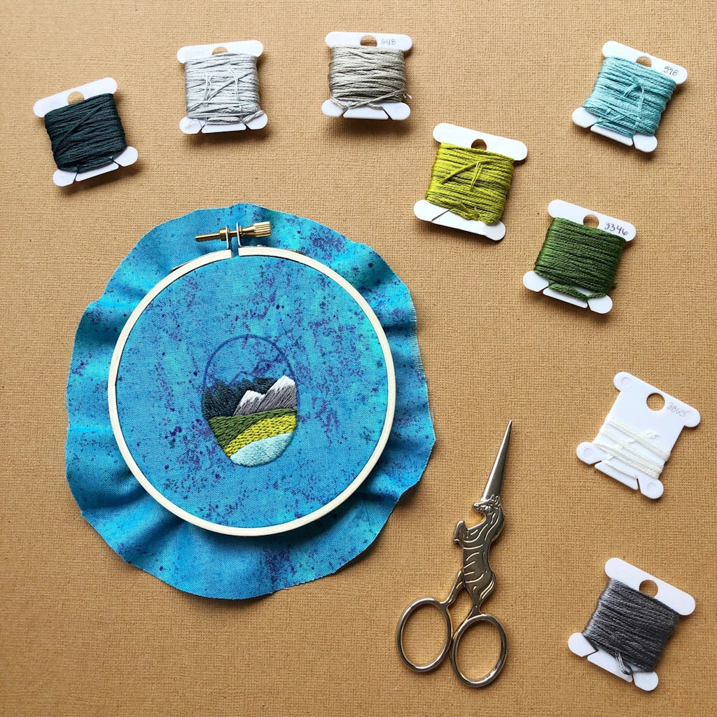 Give the gift of crafting to your crafty friend. This embroidery kit lets you create your own oval landscape pin. Available from Campanula Design Studio in Seattle.