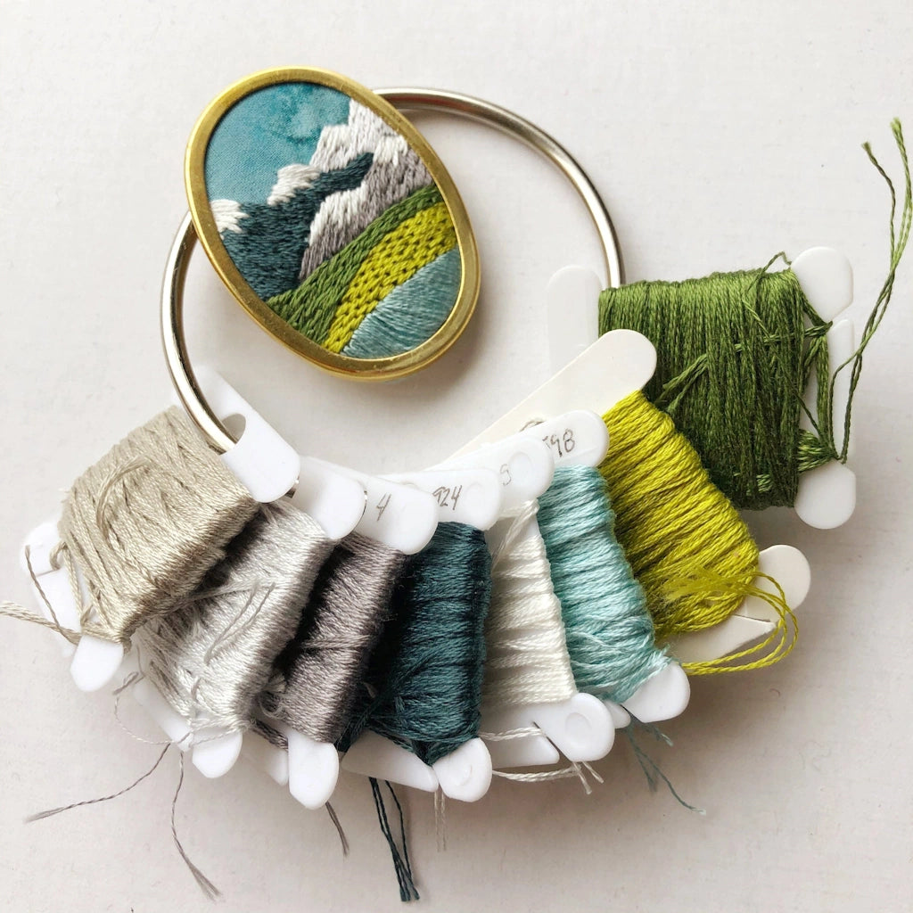 Give the gift of crafting to your crafty friend. This embroidery kit lets you create your own oval landscape pin. Available from Campanula Design Studio in Seattle.