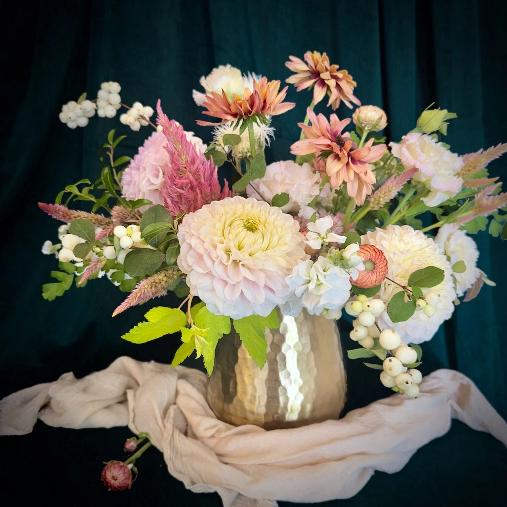 Flower arrangement with a soft collection of peach and cream toned blooms designed in a small vase by Seattle Florist Campanula Design Studio