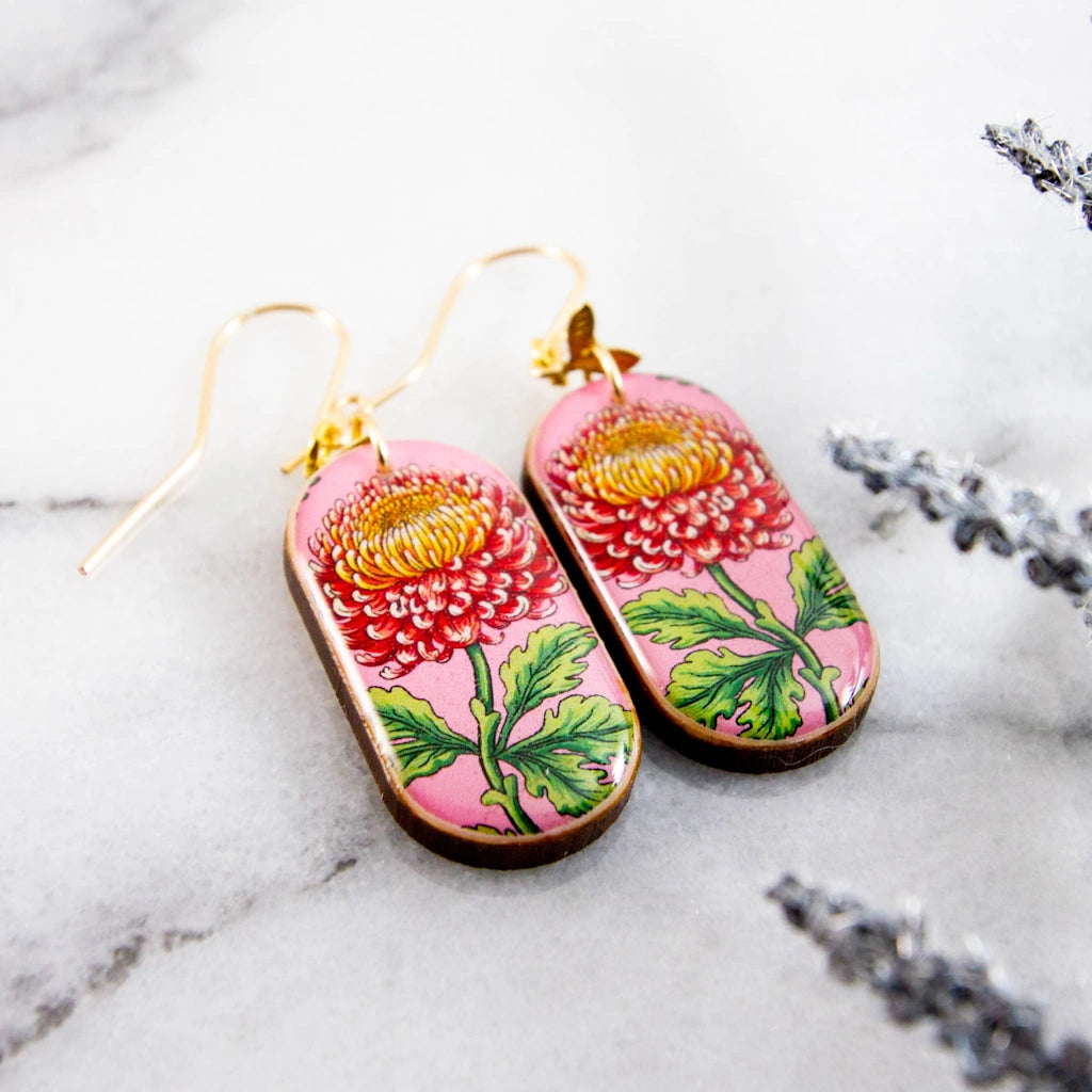 These charming earrings are a celebration of spring! Featuring a vintage inspired chrysanthemum flower illustration, rendered in shades of pink, yellow, and green. Available from Seattle flower and gift shop, Campanula Design Studio in the Magnolia neighborhood. Pickup or ship nationwide!