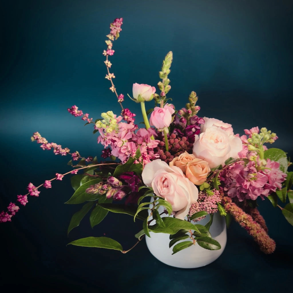 Campanula's "Raspberry Sorbet" flower arrangement features a delightful palette of pale blush, soft pink, and deeper tones in a ceramic vase.