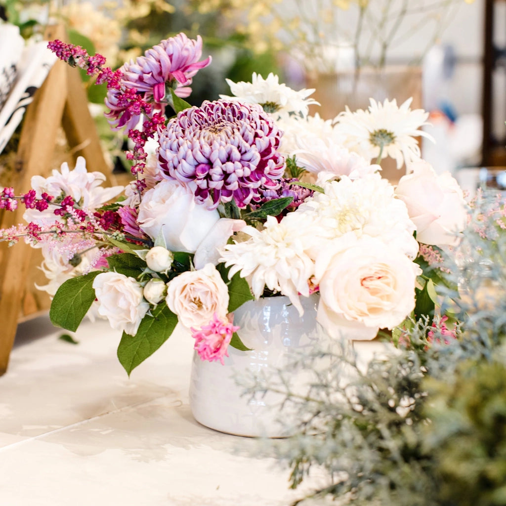 You choose the palette and we'll choose the flowers! A designer's choice arrangement of seasonal flowers in a vase from Campanula Design Studios in Seattle.