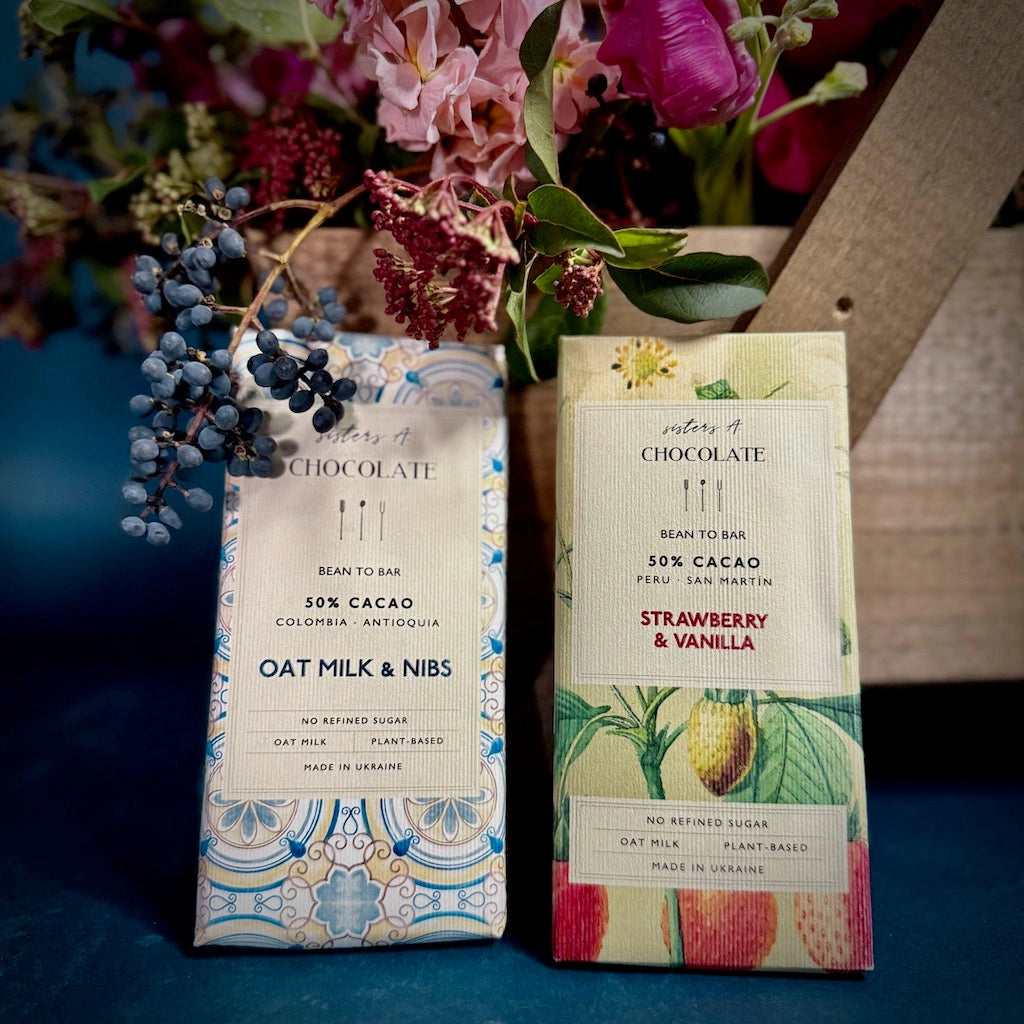 Oat Milk Chocolate Nibs bar - Sisters A Chocolate was founded by Ukrainian sisters Olena and Oleksandra in 2021. They are making beautiful craft chocolate in Lutsk amidst ongoing violence. Even getting the bars out of the country is a challenge as shipments are restricted due to the war. We're proud to be one of the first American suppliers of this beautiful chocolate.