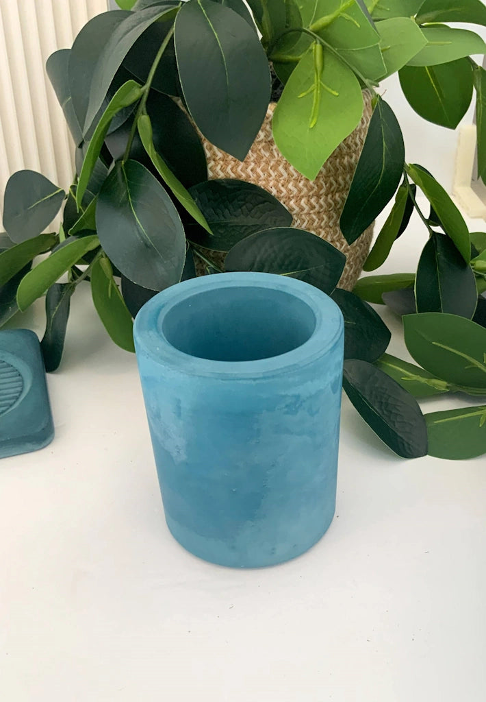 Multipurpose, handmade concrete cylindrical vessel can be used for toothbrushes, pens/pencils, coffee stir sticks, makeup brushes, air plants, small flowers, and much more! 
Available from Campanula Design Studio, Seattle's Gift Basket solution store.