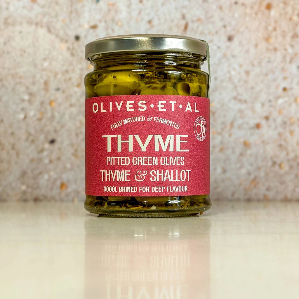 Thyme pitted green olives with a sharp tang of a crisp Shallot along with a touch of lemon. Tastes like summer in a jar. Available from Seattle florist and gift basket company, Campanula Design Studio.