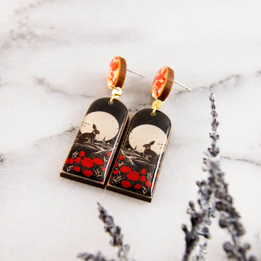 These earrings feature a vintage inspired rabbit illustration, rendered in crisp black, white, and red. Available from Campanula Design Studio in Seattle.